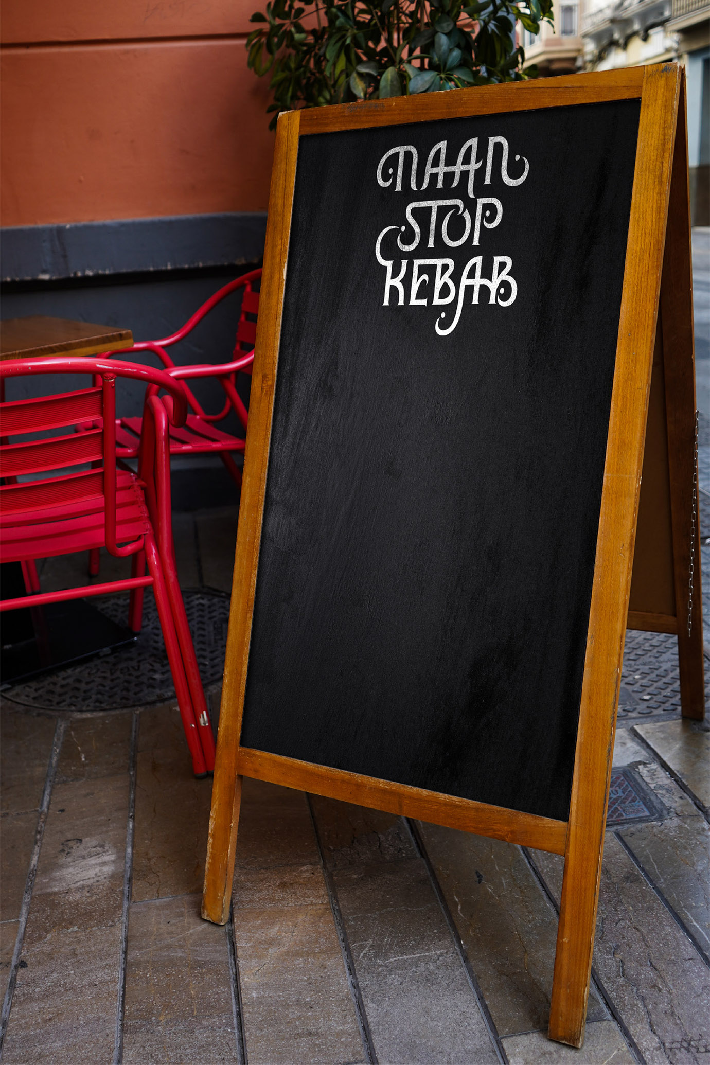 Naan Stop Kebab logo on black chalkboard